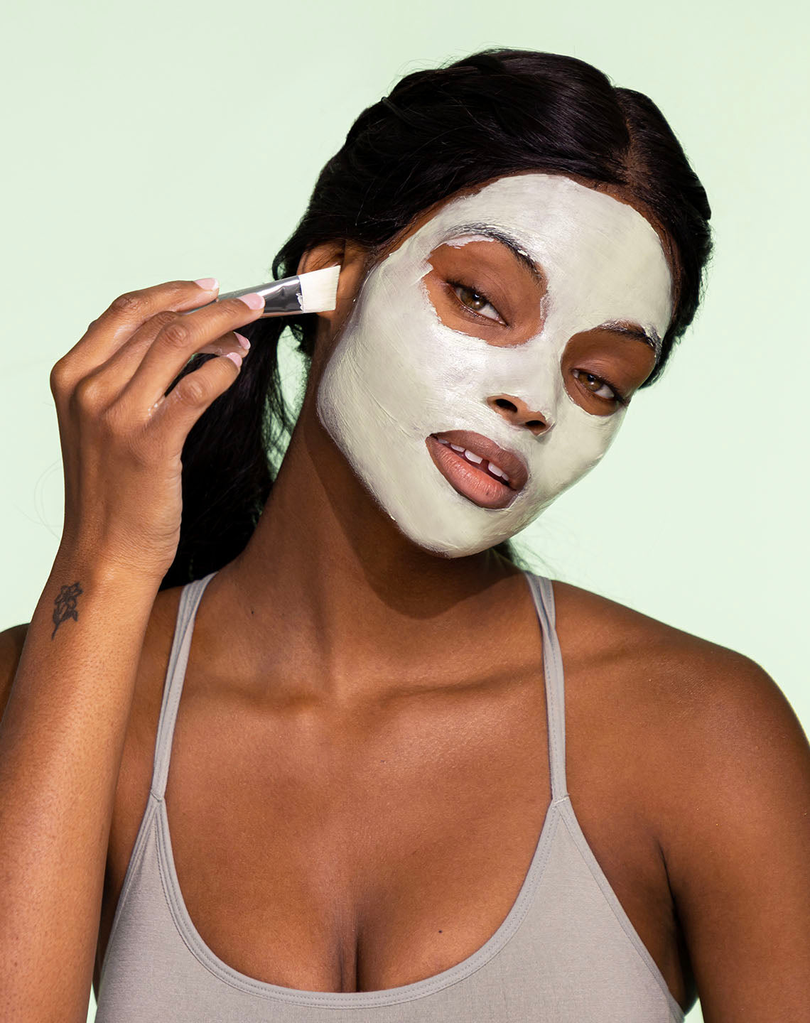 girl putting facial mask for oily skin